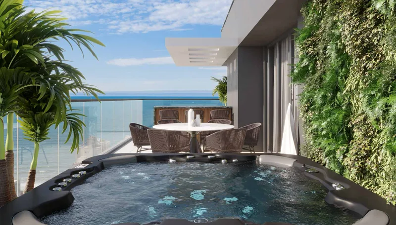 Terraço da cobertura duplex com spa, mesa de jantar externa e vista para o mar
